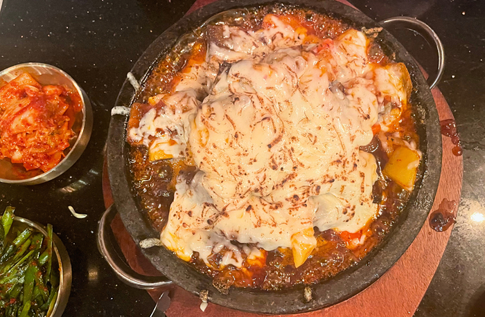Bubbling Cauldrons of Cheese-Covered Meat